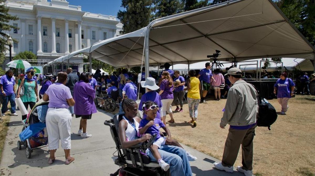 More than 4,000 home care providers and clients rallied at the state Capitol in June 2014. The state will begin paying overtime to many home-care workers starting Feb. 1.