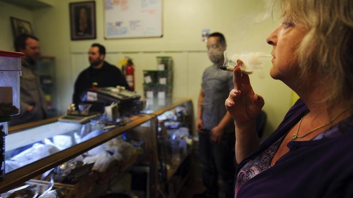 Co-founder Catherine Smith smokes marijuana at the HopeNet dispensary in San Francisco on April 10, 2012.