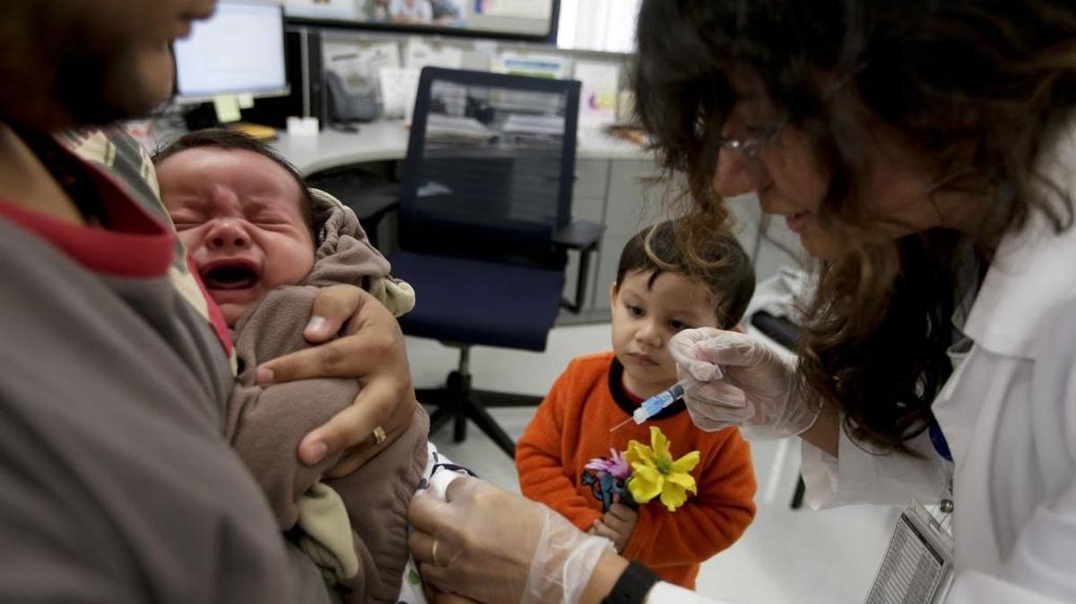 A registered Nurse at the San Diego Public Health Center gives a whooping cough injection in December 2014.