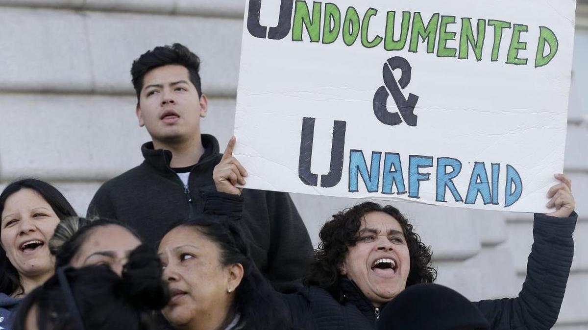 In this Wednesday, Jan. 25, 2017 file photo, Lordes Reboyoso, right, yells at a rally outside of City Hall in San Francisco.
