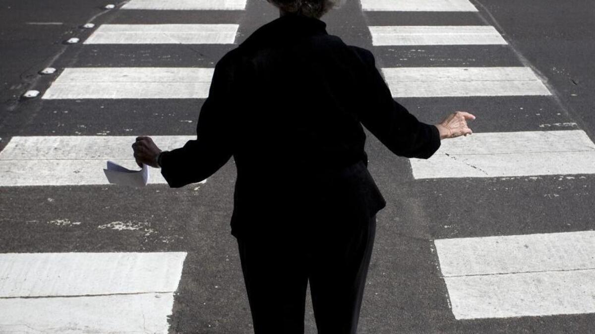 Anne Geraghty stands on the edge of a crosswalk at 13th and H streets as she waits for cars to let her cross the street on May 8, 2008.