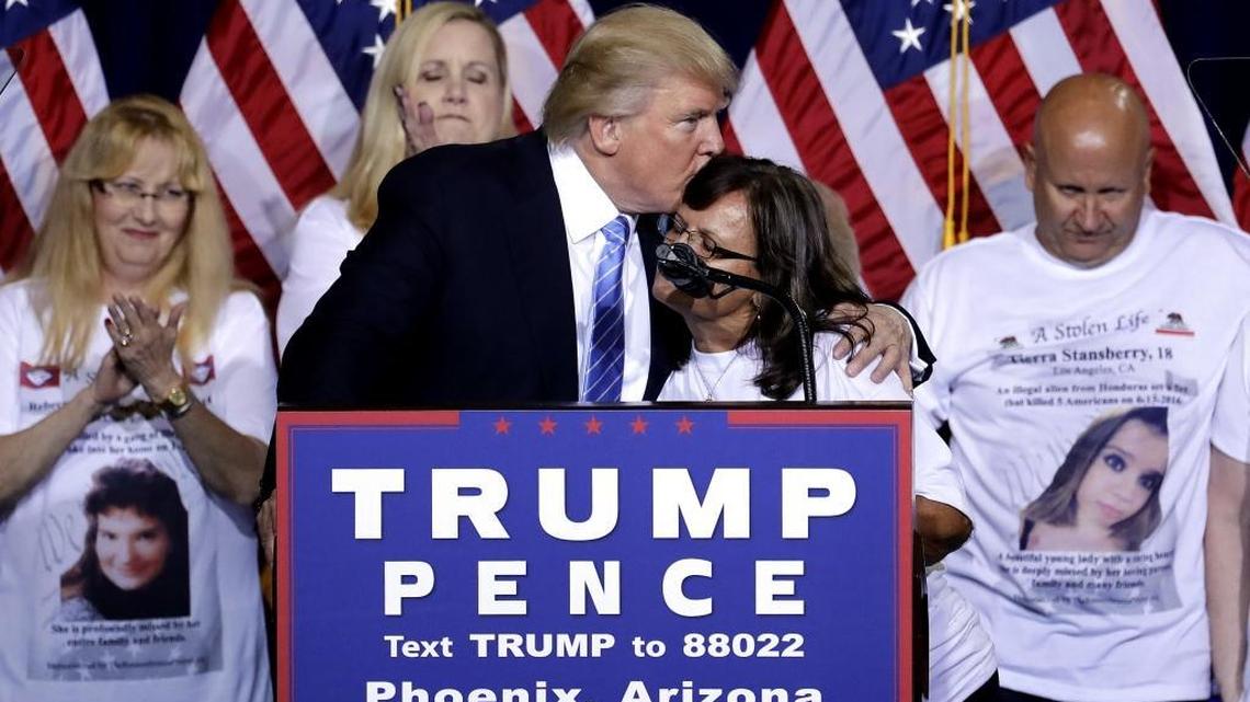 Republican presidential candidate Donald Trump hugs a woman, whose child was killed by a person living in the country without legal permission, after delivering an immigration policy speech during a campaign rally at the Phoenix Convention Center, Wednesday, Aug. 31, 2016, in Phoenix.
