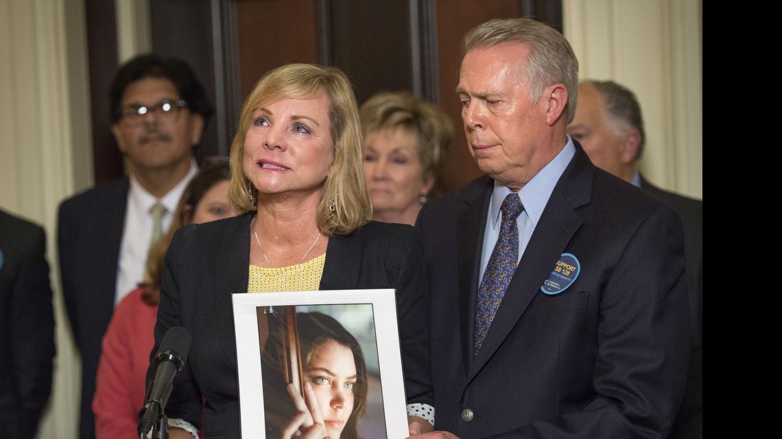 
Deborah Ziegler, with her husband Gary Holmes, holds a photo of her daughter Brittany Maynard on Thursday after the California Senate passed SB 128, a bill that would allow physicians to assist in the death of terminally ill patients

