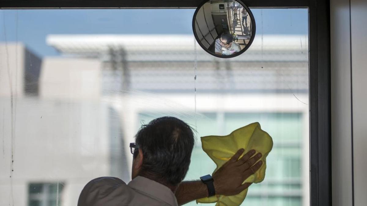 Pete Amirani of Fair Oaks cleans the window of an elevator at the UC David Medical Center in July. Amirani works with InAlliance, a Sacramento nonprofit that works with people who have developmental disabilities and receives funding from the state. Such agencies would receive a funding boost under a health plan tax package awaiting votes in the Legislature.