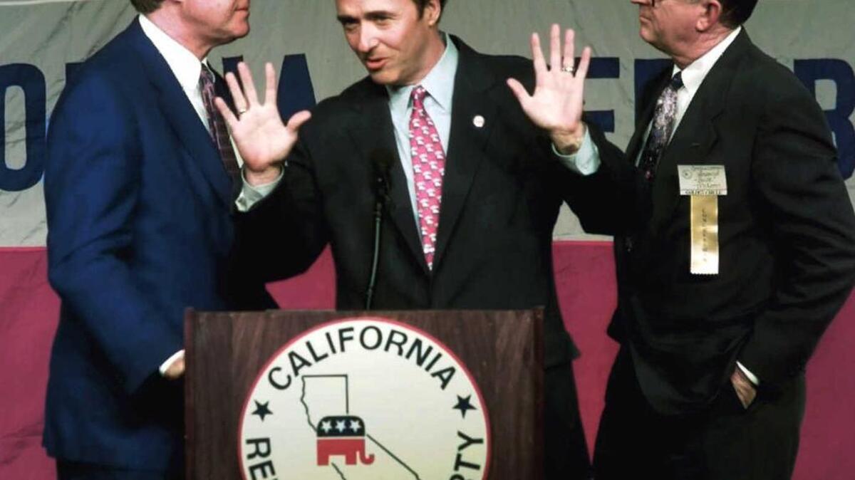 
Then-Attorney General Dan Lungren, center, gestures as he addresses the party faithful with Los Angeles County Supervisor Mike Antonovich, left, and former Rep. Howard “Buck” McKeon, looking on early in the evening in Universal City on March 26, 1996.
