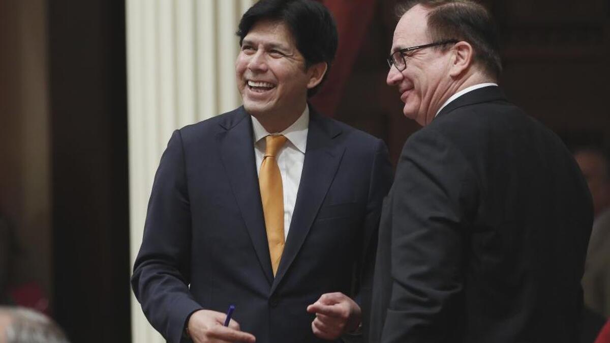 State Senate President Pro Tem Kevin de Leon, D-Los Angeles, left, smiles as his gun control bill SB 1235 is approved by the Senate on May 19. At right, is Sen. Bob Huff, R-San Dimas.