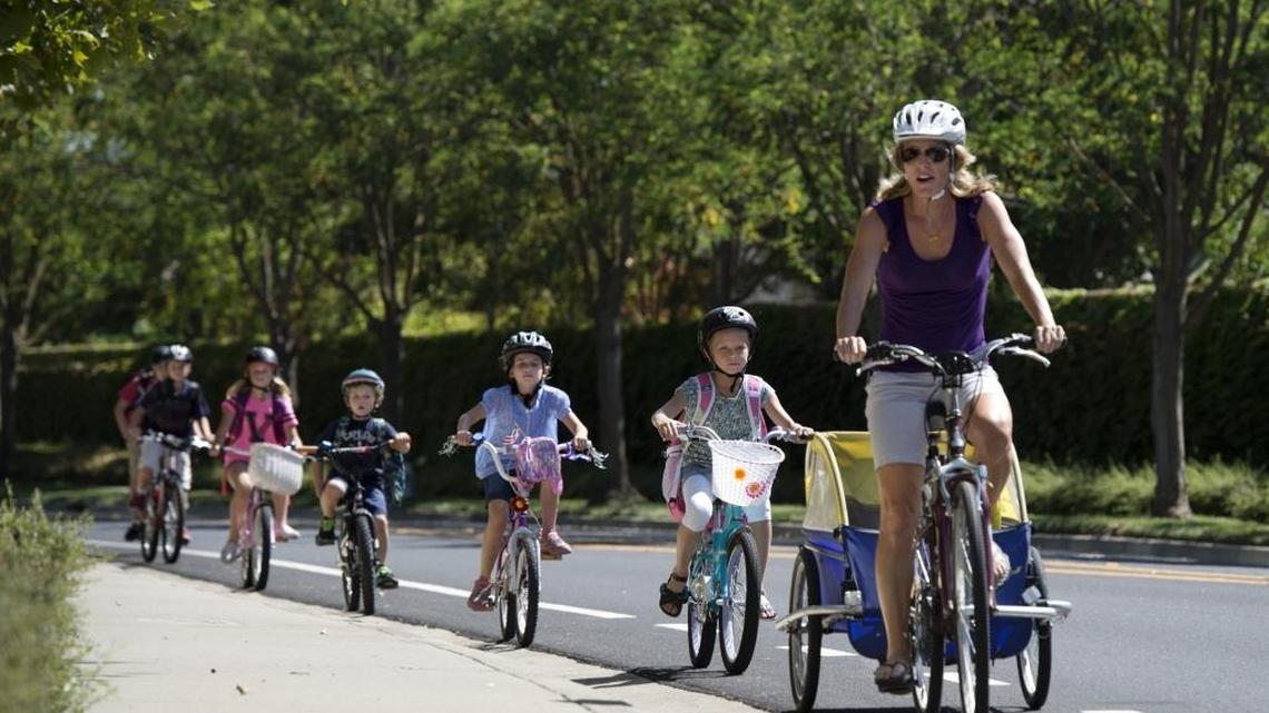 Tagging along like a team of ducklings, Beth Mahony leads a group of neighborhood elementary school kids home from Heron School in North Natomas as part of the "Walking School Bus" program.