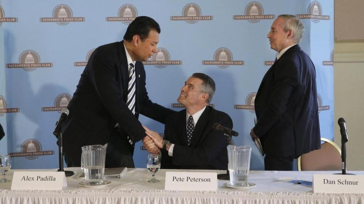 In April 2014, state Sen. Alex Padilla, D-Los Angeles, left, shakes hands with Republican opponent Pete Peterson after a secretary of state candidates debate. No-party preference candidate Dan Schnur is at right.