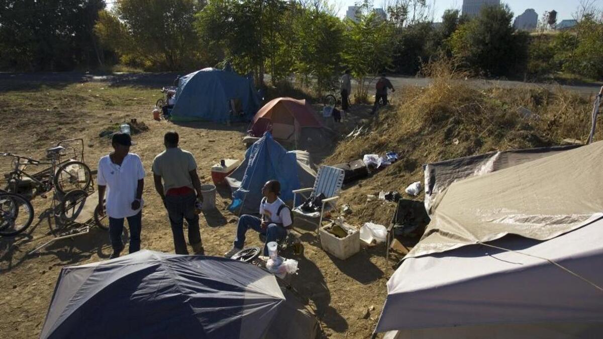 Lester Washington, 60, left, a Vietnam veteran, and Victor Taylor, 41, right, set up tents on Union Pacific Railroad property near 7th and B streets in Sacramento in 2007.