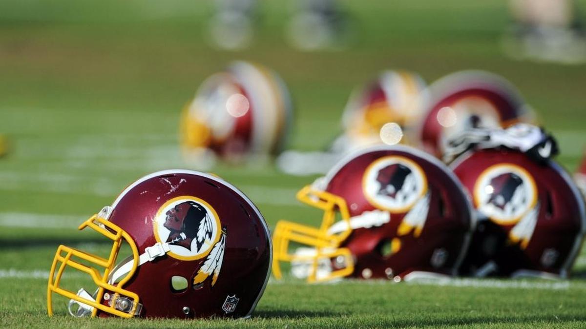 
In this June 17, 2014, file photo, Washington Redskins helmets sit on the field during an NFL football minicamp in Ashburn, Va. The U.S. Patent Office ruled Wednesday, June 18, 2014, that the Washington Redskins nickname is "disparaging of Native Americans" and that the team's federal trademarks for the name must be canceled.
