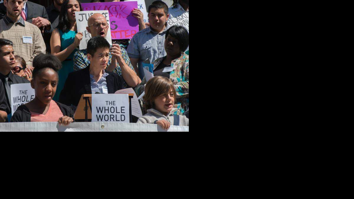 
Christine Sun, center, associate director of the ACLU, pauses while speaking at a rally outside the state Capitol for legislation to better monitor police officers on Monday.
