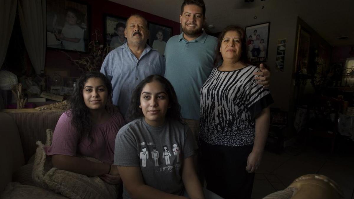 Edwin Valdez, 21, with his twin sisters Iridiun, center, Jennifer and parents Francisco and Luz Elena in their Sacramento home on Friday, Aug. 4. The Valdez children are college students, Edwin can petition for green cards for his undocumented parents, and is a proponent of keeping the current relative-centric system.