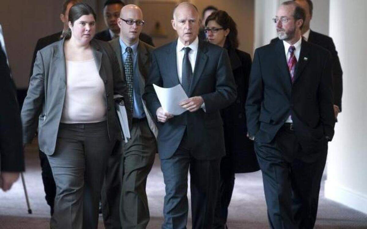 
Gov. Jerry Brown, center, walks with Ana Matosantos, former director of California Department of Finance, left, Michael Cohen, then-Chief Deputy Director of Department of Finance, and ex-adviser Steve Glazer, right, to a meeting with the League of California Cities in 2011.
