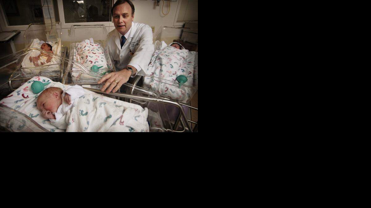 
Dr. William Gilbert, the regional medical director of Sutter Women’s Services, is shown in 2007 with four babies of hundreds that are born every month at the hospital.
