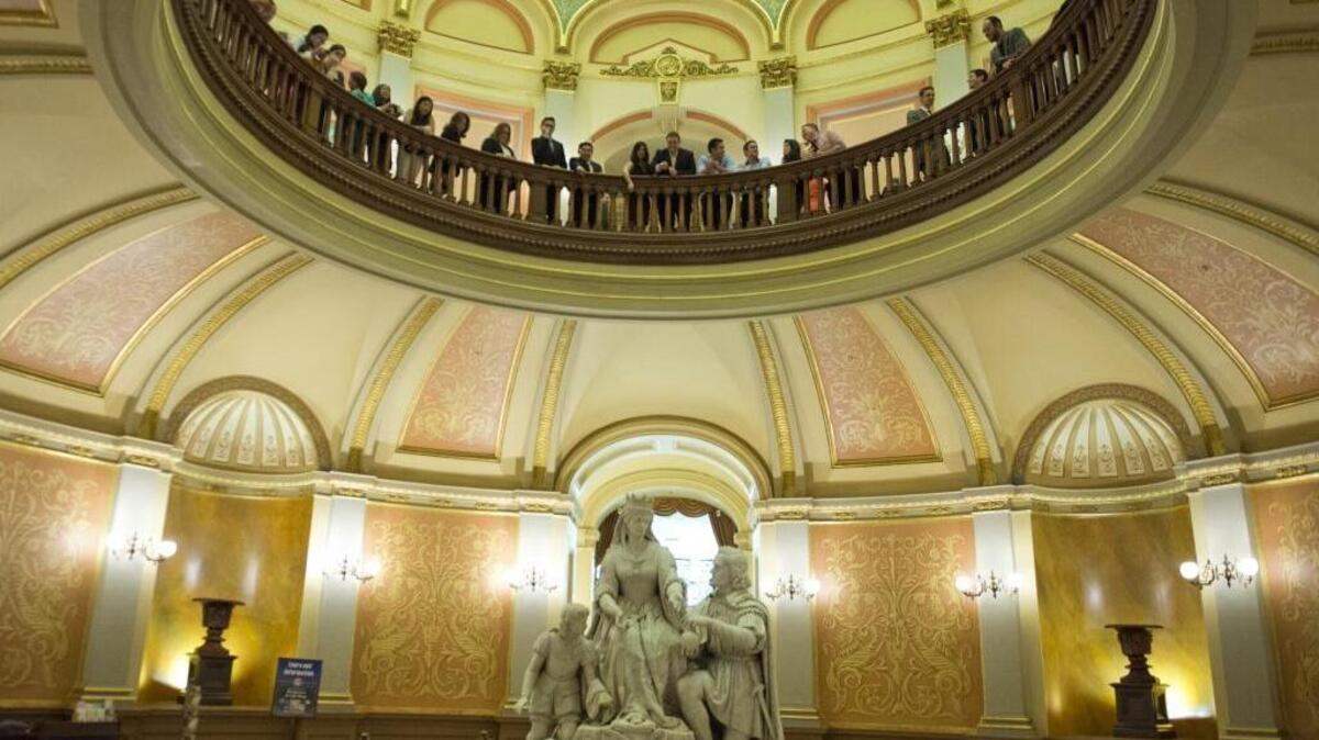 Some toss pennies at Queen Isabella’s crown on the Capitol rotunda as a last night of session tradition on Aug. 30, 2014.