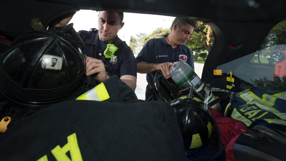 Alameda firefighter-paramedics Patrick Corder, left, and Armando Baldizan make sure that their equipment is in order in their response truck, out the City Hall West office on Alameda Point on April 5, 2017.