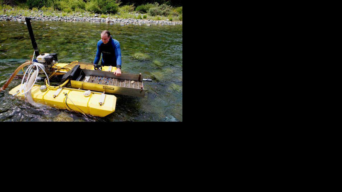 
In this 2006 file photo, Bill Kinzie checks his equipment as he dredges for gold in the Yuba River near Camptonville, Calif. A judge has declared that the state’s moratorium on using suction dredges to sift through gravel violated federal mining law.
