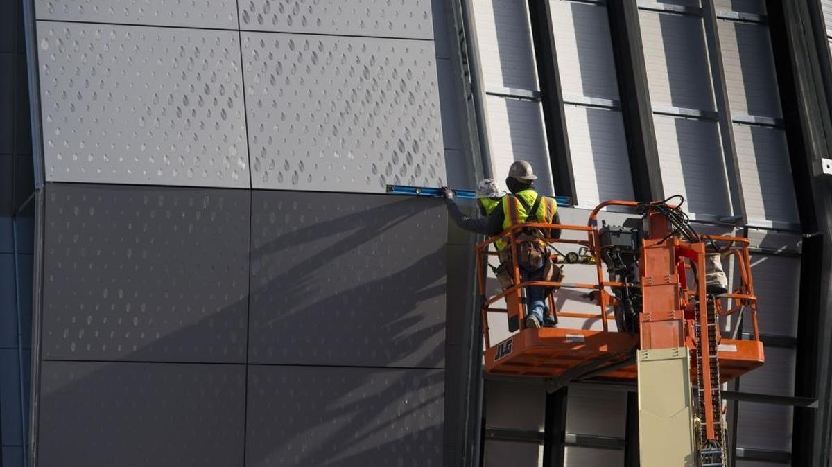 A Turner Construction worker levels a panel that he was installing at the Golden 1 Center, Sacramento’s new professional basketball arena, on Nov. 25, 2015. Construction carries some of the state’s highest costs of insurance for job-related injuries.