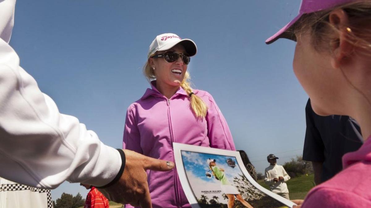 LPGA golfer and Sacramento native, Natalie Gulbis, signs autographs for fans, as Maya Holmes, 7, waits to have a photograph signed, right, during a clinic at Haggin Oaks golf course on April 6, 2012.