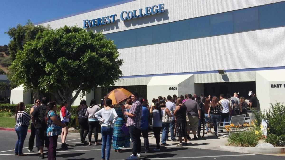 In this April 28, 2015 file photo, students wait outside Everest College in Industry, Calif., hoping to get their transcriptions and information on loan forgiveness and transferring credits to other schools. Everest and other Corinthian College, Inc.-owned school, Wyotech, gave inaccurate job placement rates to students.