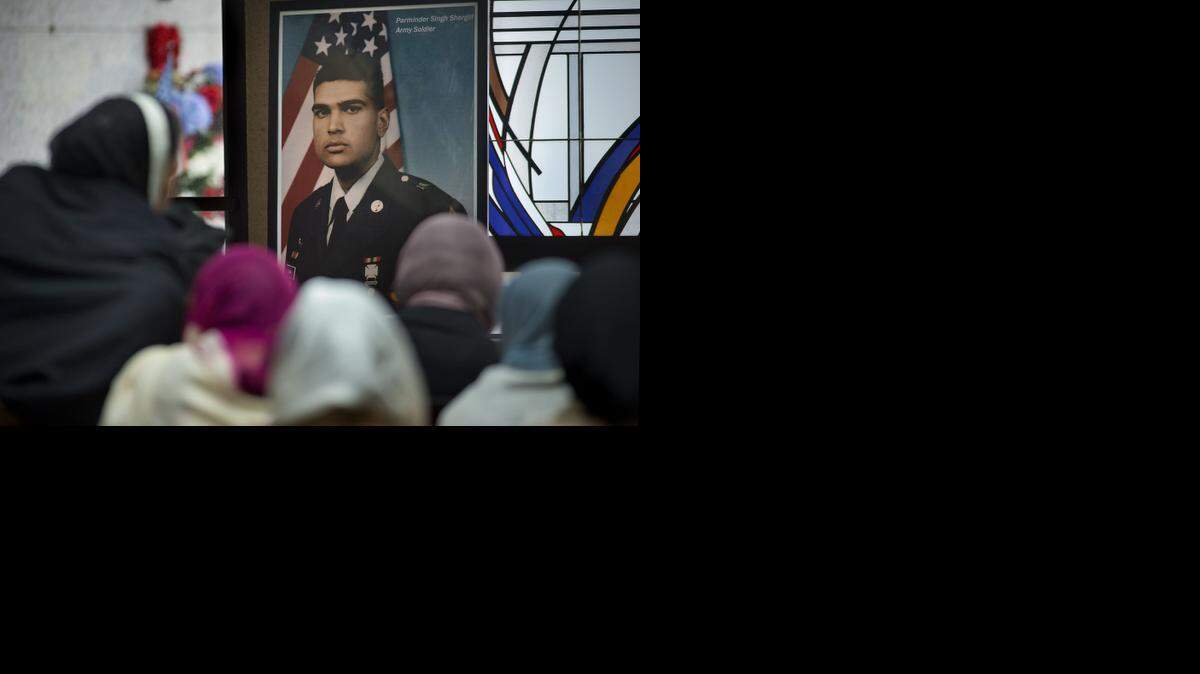 
A photograph of Parminder Singh Shergill is displayed near his body during the funeral services for him at Cherokee Memorial Park in Lodi on Saturday, February 8, 2014. 

