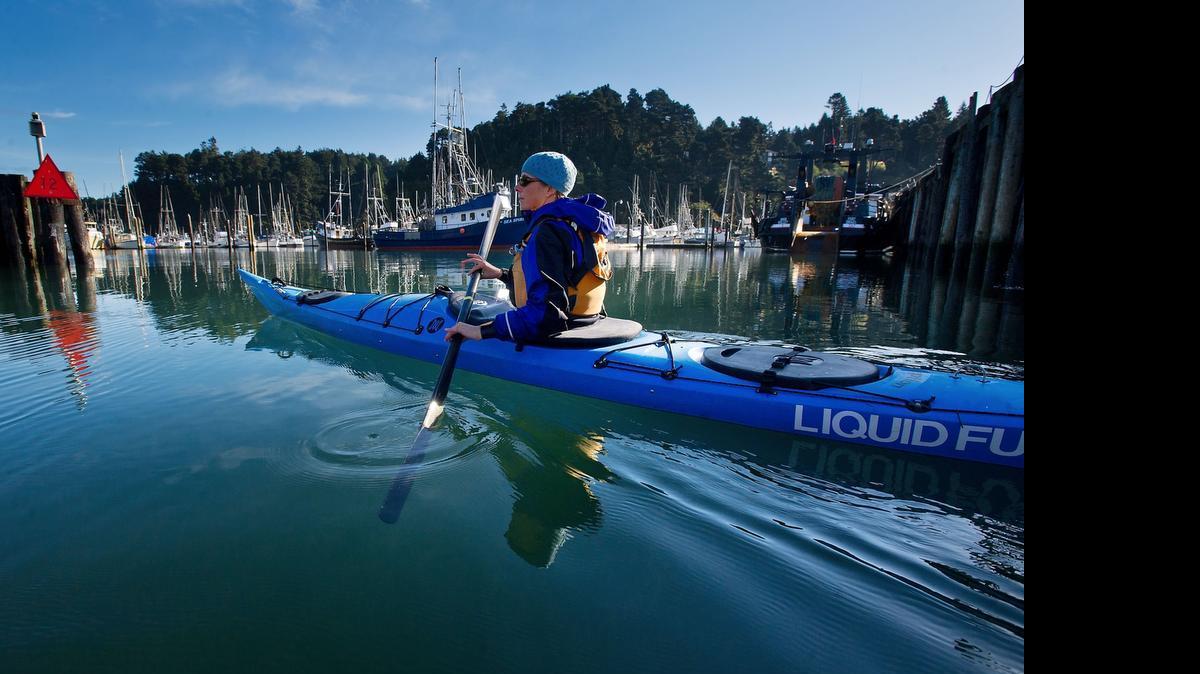 
Cate Hawthorne of Liquid Fusion Kayaking paddles through the Noyo River marina in Fort Bragg in 2012
