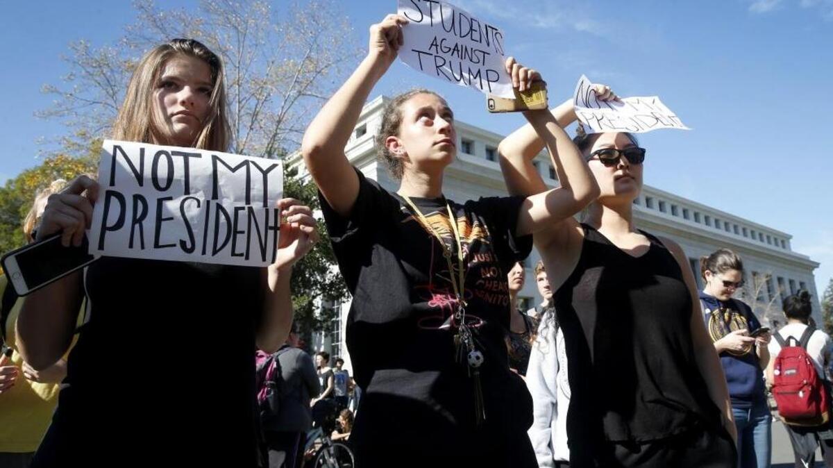 Albany High School students Lily Hopwood, Lulu Lebowitz and Tanan Javkhlantugs joined thousands of others on a march to the University of California, Berkeley campus Wednesday, Nov. 9, 2016, to protest the presidential election of Donald Trump in Berkeley, Calif.