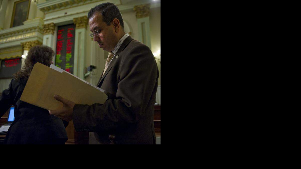 
Then-Assemblyman Tony Mendoza, D-Artesia, looks over paper work as he prepares to vote on DB 77 during the Assembly vote on a state budget plan at the state Capitol on Wednesday, March 16, 2011. 
