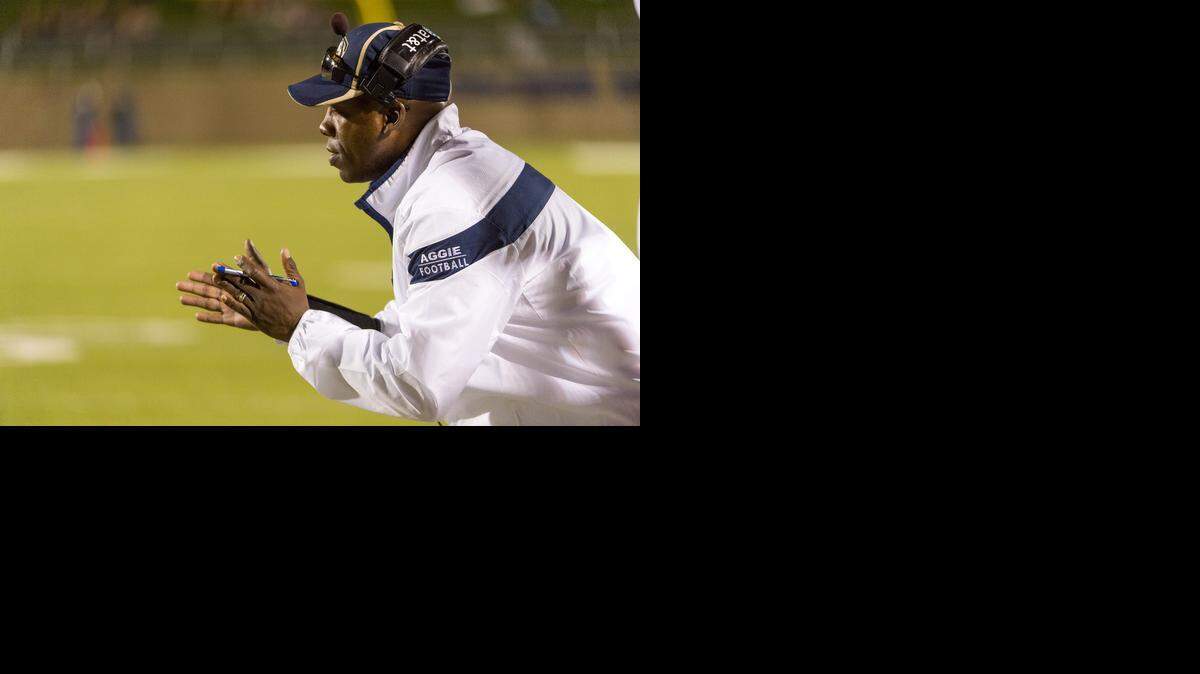 
UC Davis head football coach Ron Gould cheers on his team during a game against the Eastern Washington Eagles on Sept. 27, 2014.
