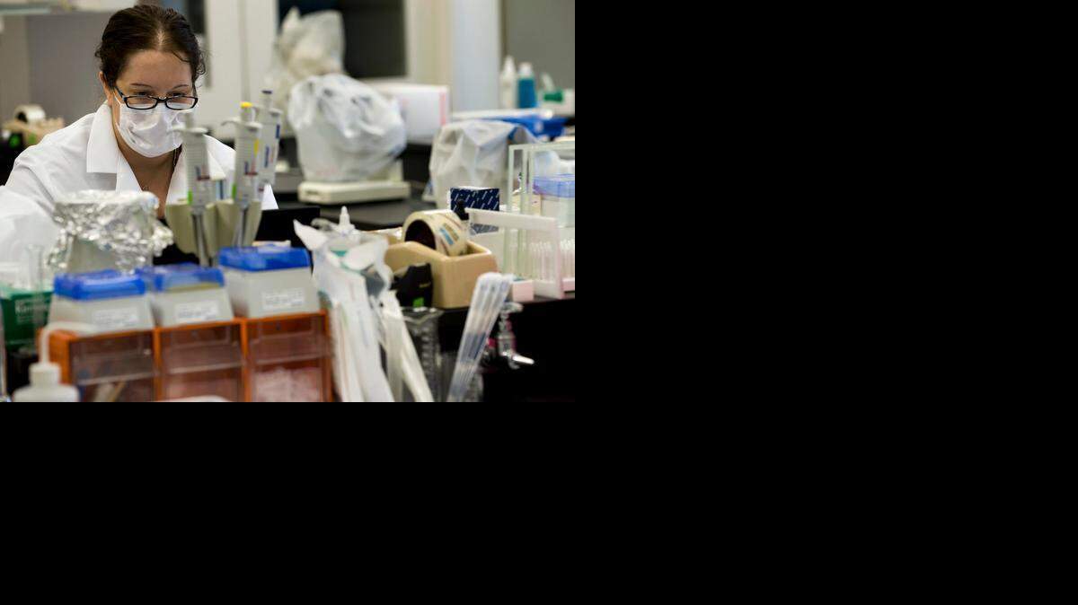 Nikki Sewell, a Criminalist with the Sacramento District Attorney's Crime Lab, works on DNA samples in 2010.