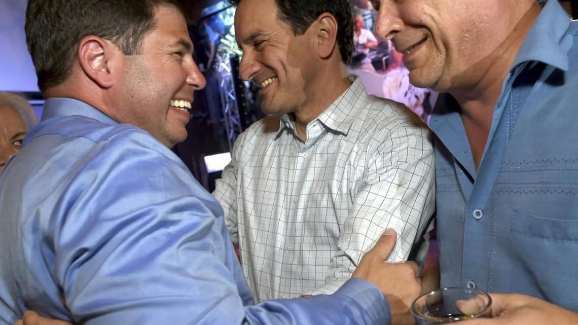 Joaquin Arambula, left is congratulated by State Assembly Speaker Anthony Rendon,center, and Eric Bauman, vice chairman of the California Democratic Party, right, during Arambula's election party in April. Democrats had a significant cash-on-hand advantage at the end of June.