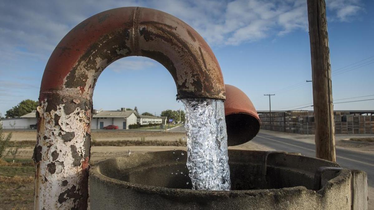 Water is pumped on a field near Woodville School in Tulare County on Tuesday Sept. 13, 2016.