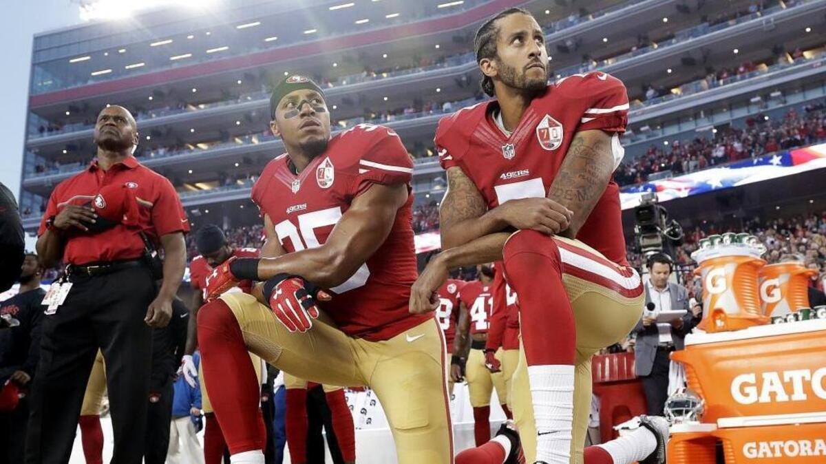 San Francisco 49ers quarterback Colin Kaepernick, right, safety Eric Reid kneel during the national anthem before a season-opening win over the Los Angeles Rams on Sept. 12, 2016.
