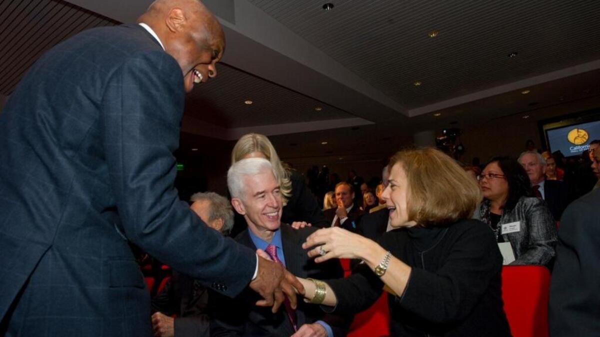 Former Assembly Speaker Willie Brown greets Anne Gust wife of Gov.-elect Jerry Brown and former Gov. Gray Davis on Tuesday, Dec. 14, 2010 in Sacramento.