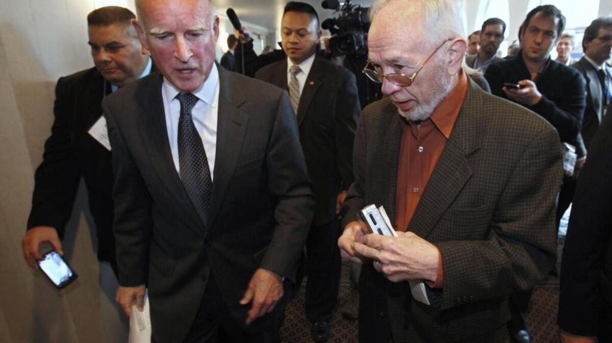 In this Wednesday, Jan. 19, 2011 photo former Associated Press Correspondent Doug Willis, right, talks with Gov. Jerry Brown in Sacramento, Calif. Willis, who covered California politics for the AP for more than three decades, passed away Tuesday, Dec. 15, 2015, from complications following hip surgery.