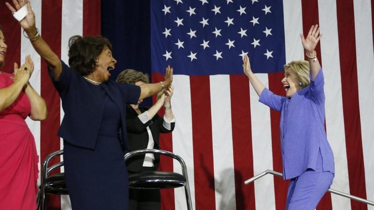Democratic presidential candidate Hillary Clinton, right, takes the stage at a rally, Friday, June 3, 2016, in Culver City, Calif.