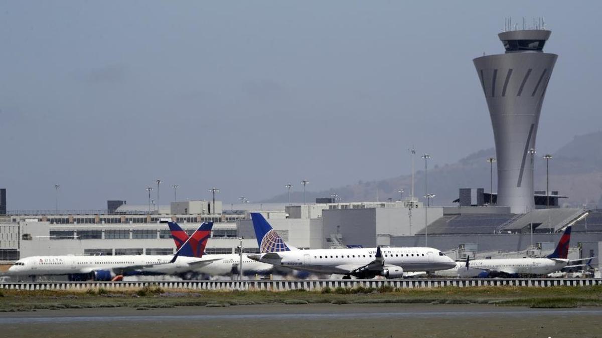 Departing and parked aircraft intersect at San Francisco International Airport on July 11, 2017, in San Francisco. An Air Canada Airbus A320 was cleared to land on one of the runways at the San Francisco airport just before midnight on Friday, July 7, when the pilot "inadvertently" lined up with the taxiway, which runs parallel to the runway. There were other aircraft lined up on the taxiway waiting for departure when the incident occurred.