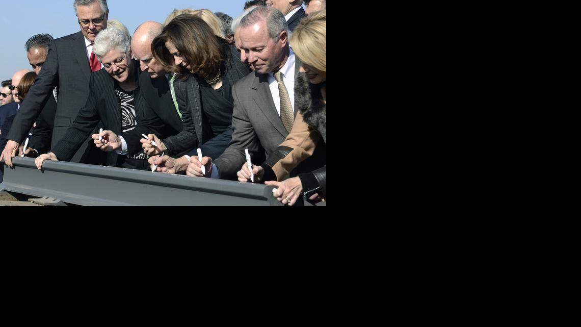 Governor Jerry Brown, center, signs a section of rail, flanked by his wife, Anne Gust Brown, center right, and Gina McCarthy, Administrator for the EPA, center left, and other dignitaries sign at the groundbreaking for High Speed Rail on Tuesday.