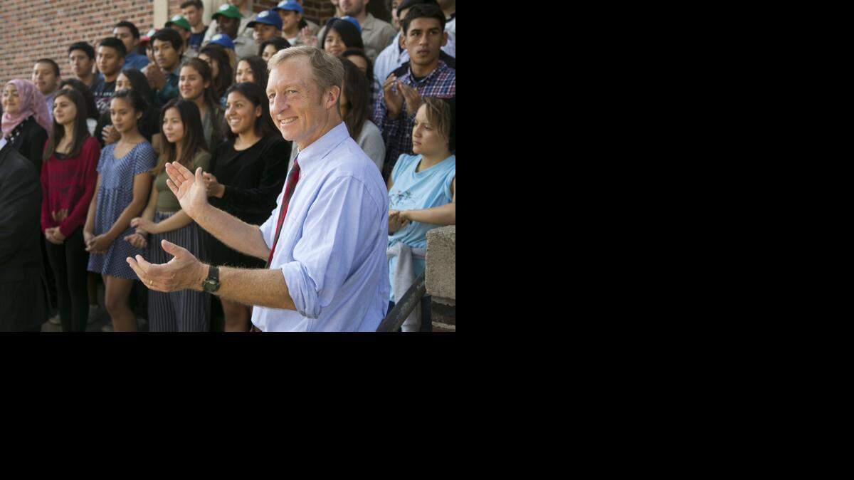 
California Prop. 39 co-chair Tom Steyer takes photos with students at John Marshall High School in Los Angeles Tuesday in 2014.
