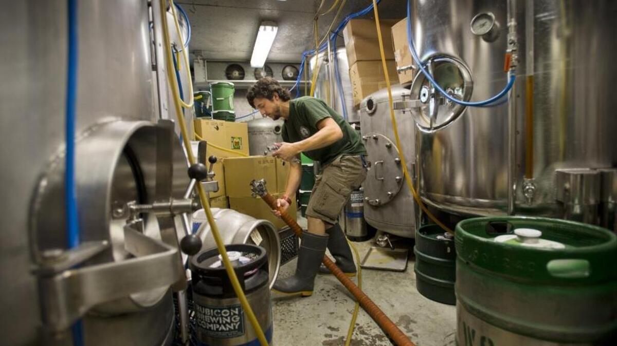 
Chris Keeton filters and transfers IPA between tanks at the Rubicon Brewing Company in Sacramento on June 23, 2014.
