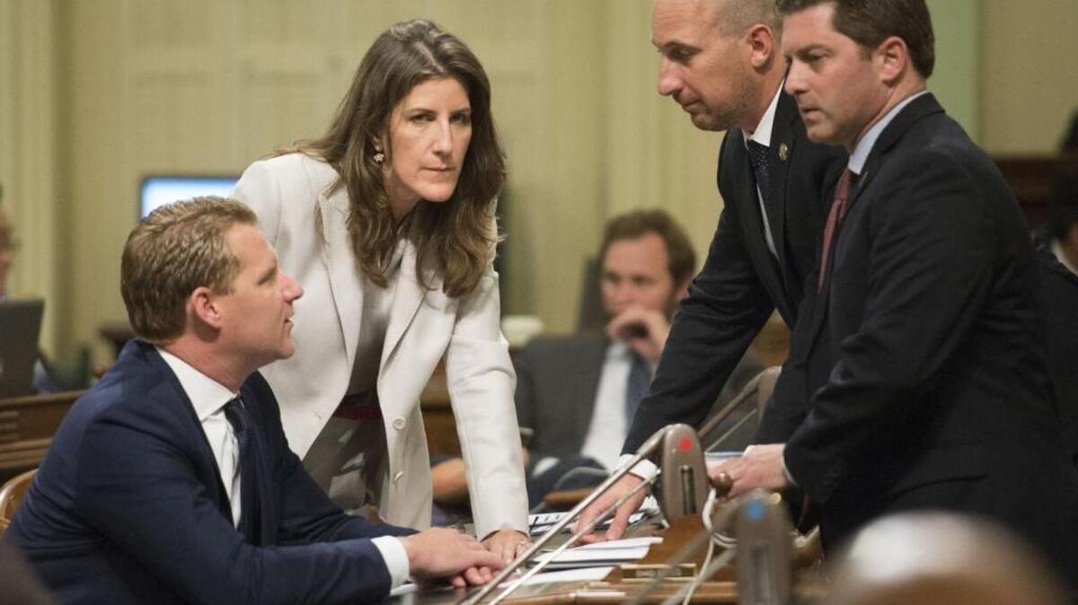 Assembly Republican Leader Chad Mayes, left, speaks with Assemblywoman Catharine Baker, R-Dublin, Assemblyman Heath Flora, R-Ripon, and Assemblyman Jordan Cunningham, R- Templeton, during the vote on key climate change legislation on July 17, 2017.