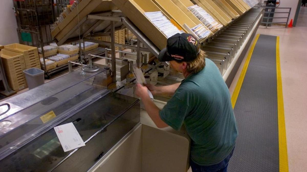 
Phil Rothrock, a tax preparation assistant at the State Franchise Tax Board, receives incoming tax returns through a mail sorter on February 16, 2006. Personal income taxes accounted for $55 billion of the nearly $412 billion in state and local revenues in 2012. Sacramento Be/ Lezlie Sterling
