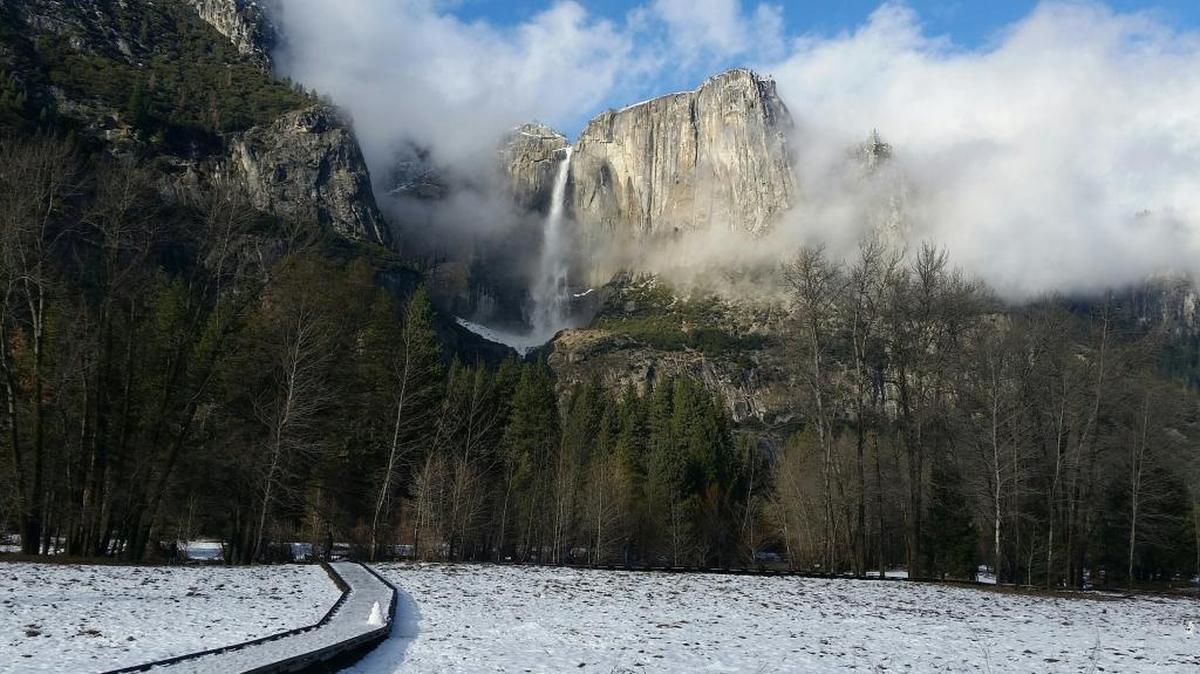 This undated image provided by the National Park Service shows Yosemite Falls in Yosemite National Park in California in winter. The park is less crowded in winter and offers solitude, scenery and activities like hiking, snowshoeing, skiing and ice skating.