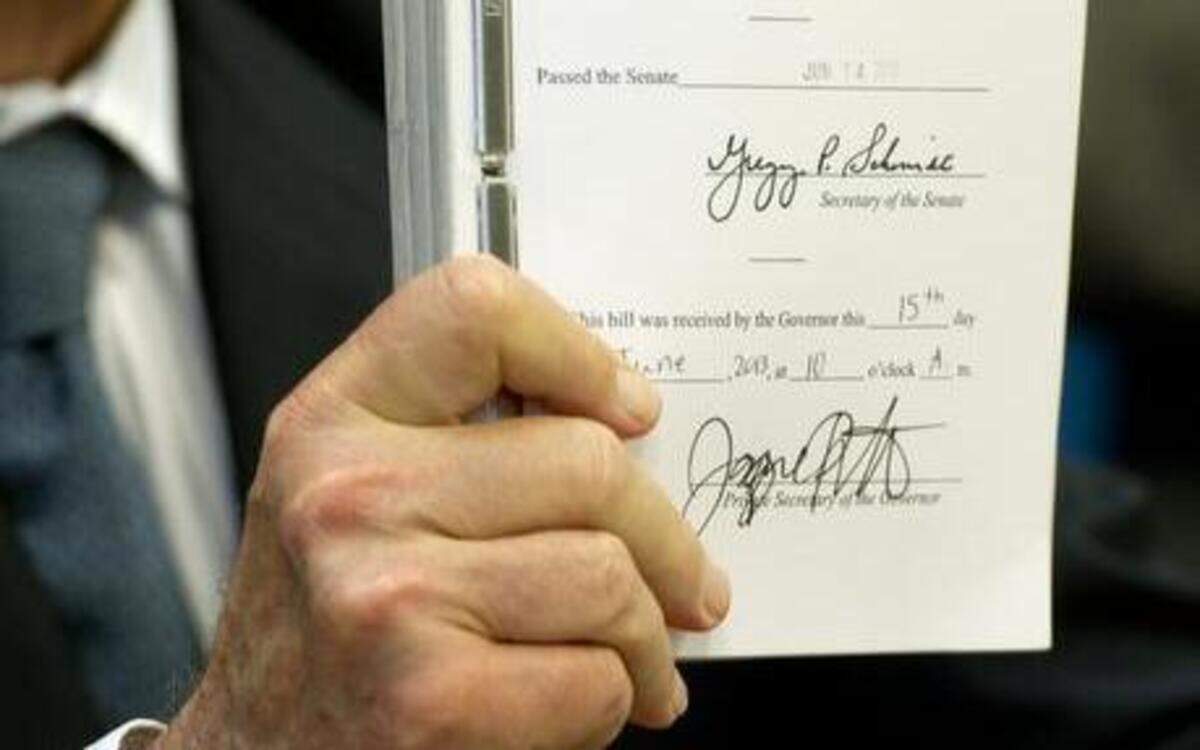 
Gov. Jerry Brown holds up the state budget he signed in 2013.
