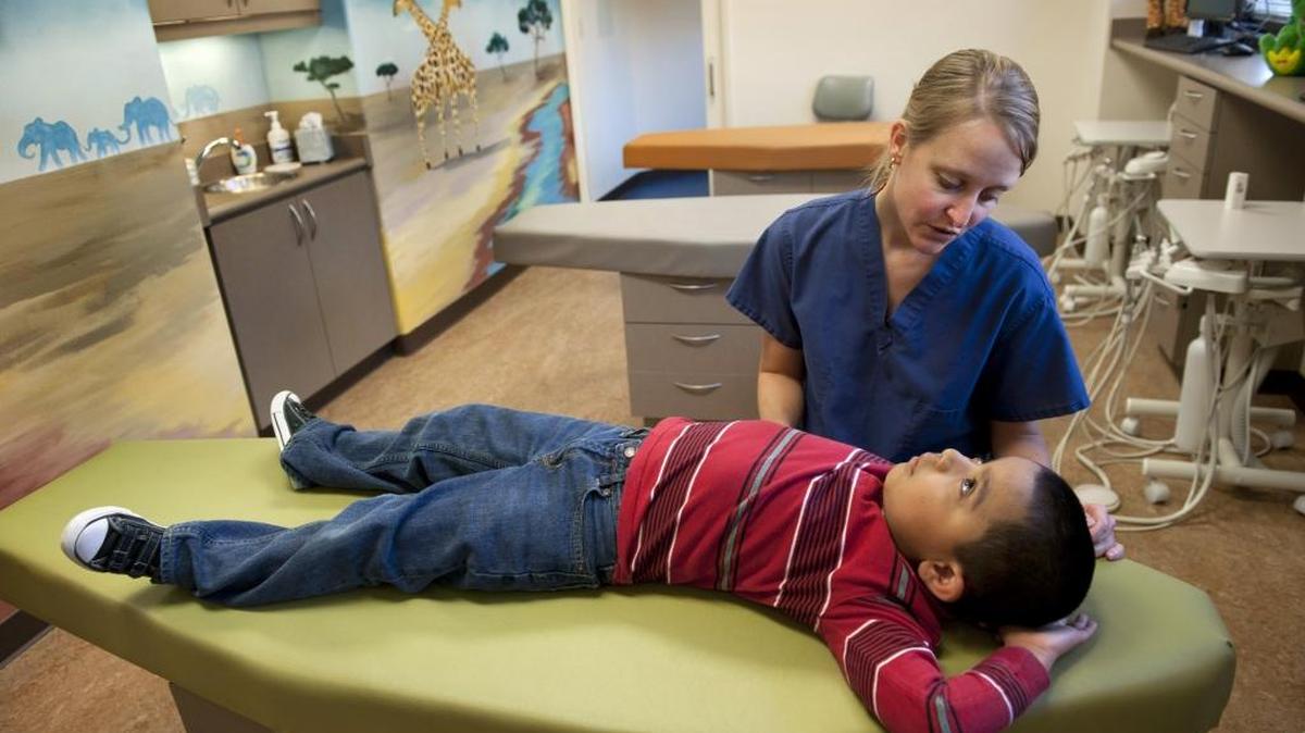 In 2011, a dentist talks with a patient during an exam at the Effort's Oak Park dental clinic, where a vast majority of kids they see are on Denti-Cal. Legislative Republicans have asked Gov. Jerry Brown to propose $200 million additional money to increase Denti-Cal reimbursement rates.