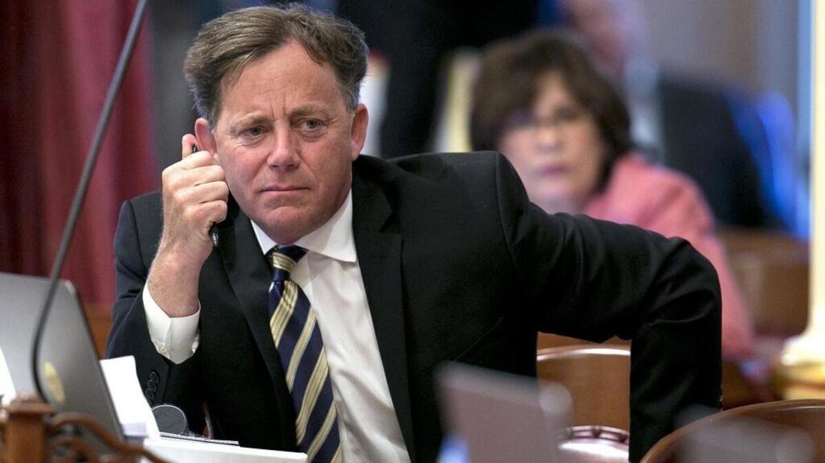 In this June 15, 2017 file photo state Sen. Josh Newman, D-Fullerton, listens as lawmakers debate a measure to change the rules governing recall elections, at the Capitol, in Sacramento, Calif. Records show that an attorney for Senate Democrats spoke behind the scenes with Fair Political Practices Commission member Brian Hatch before the commission voted change a longstanding rule that restricts how much money Newman can raise from fellow lawmakers to fight a recall.(AP Photo/Rich Pedroncelli, file)