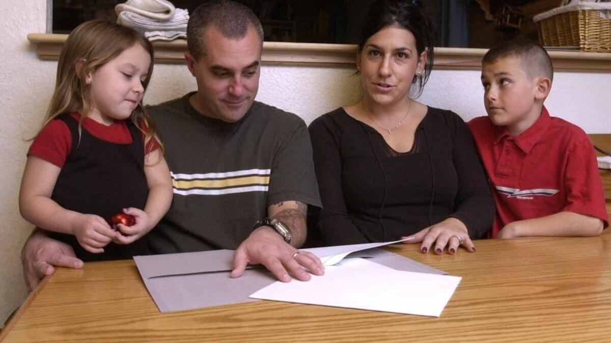 Modesto residents look over tax forms and talk about a bill in the Legislature to establish a military family relief charitable checkoff on tax returns on Feb. 2, 2004.