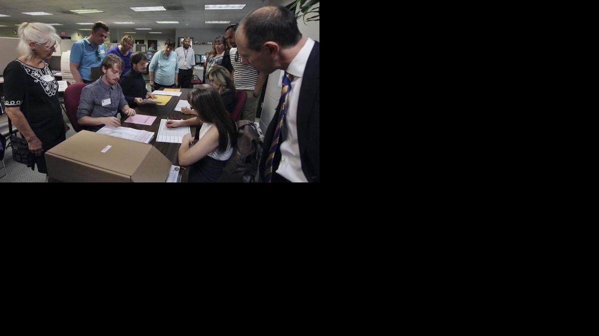 
Observers watch Micah Kagler, seated, second from left, of the Kern County Elections Division, read a ballot cast in the primary race for California controller. The July recount requested by former Assembly Speaker John A. Pérez ended just days after it started. 
