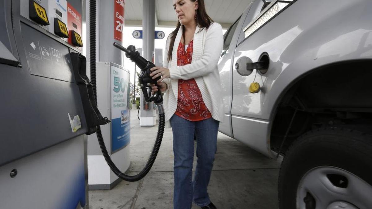 Lydia Holland replaces the gas nozzle after filling up at a gas station in Sacramento in 2014. The California gas tax to pay for road improvements pushed by Gov. Jerry Brown and Democrats could go before voters for repeal.
