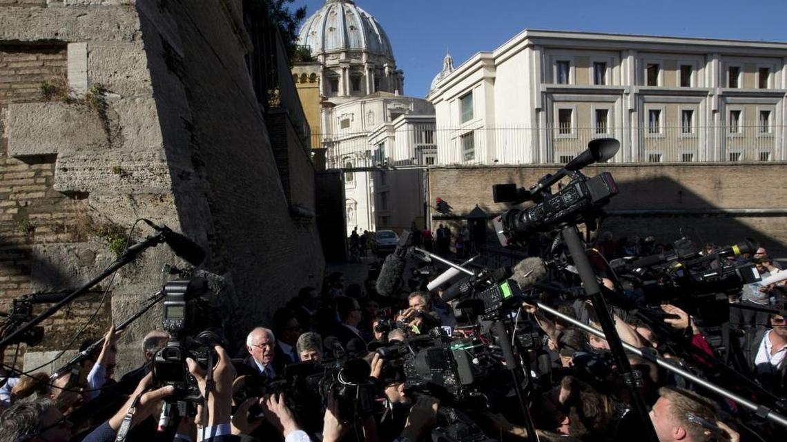 Backdropped by St. Peter's Basilica dome, US presidential candidate Bernie Sanders meets reporters outside the Perugino gate at the Vatican, Friday, April 15, 2016.